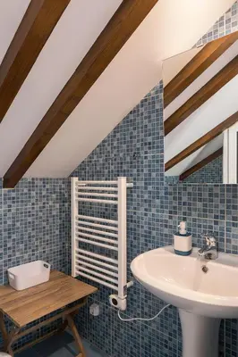 a bathroom with a sink and blue tiles at Corman House, Sea View & Pool in Arco da Calheta