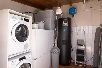 a laundry room with a washing machine and a washer at Corman House, Sea View & Pool in Arco da Calheta