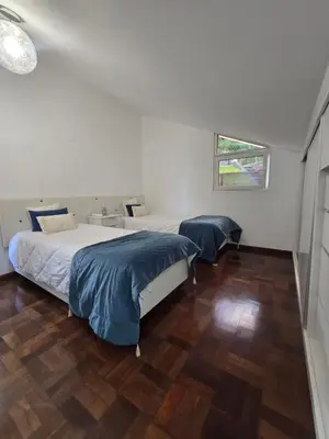 a bedroom with two beds and a window at Casa dos Amigos Panoramic View in Funchal