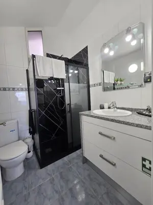 a bathroom with a shower and a toilet and a sink at Casa dos Amigos Panoramic View in Funchal
