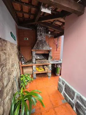 a patio with an outdoor oven in a house at Casa dos Amigos Panoramic View in Funchal