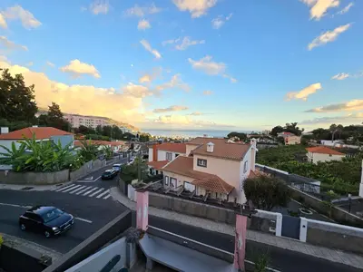 a view of a street in a town with a car at Casa dos Amigos Panoramic View in Funchal
