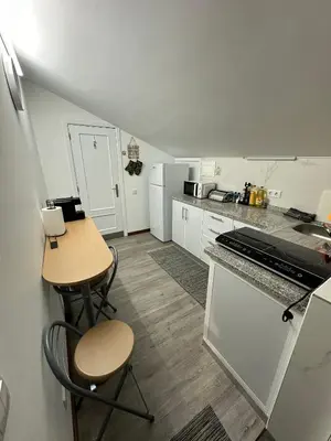 a small kitchen with a table and a counter at Casa dos Amigos Panoramic View in Funchal