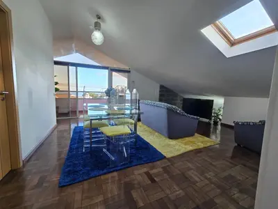a living room with a dining table and a blue rug at Casa dos Amigos Panoramic View in Funchal