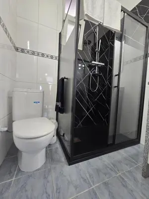 a bathroom with a toilet and a glass shower at Casa dos Amigos Panoramic View in Funchal