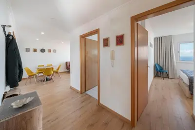 a living room with a door leading to a dining room at Garajau VI by An Island Apart in Santa Cruz