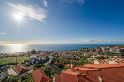 an aerial view of a city and the ocean at Garajau VI by An Island Apart in Santa Cruz