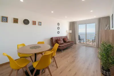 a living room with a table and chairs and a couch at Garajau VI by An Island Apart in Santa Cruz