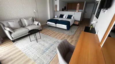 a living room with a bed and a couch at Villamar in Salema