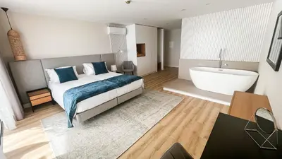 a bedroom with a bed and a bath tub at Villamar in Salema