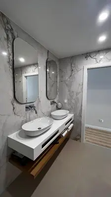 a bathroom with two sinks and two mirrors at Villamar in Salema