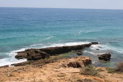 a view of the ocean with a rocky coastline at Breathtaking Villa with infinity pool over the sea in Luz
