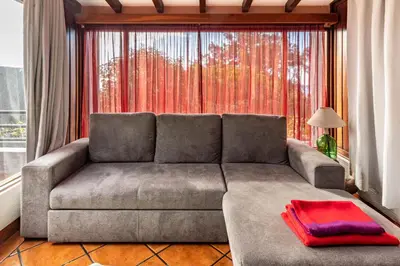 a living room with a couch and a large window at Cayenne House in Santa Cruz