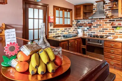 a bowl of fruit on a table in a kitchen at Cayenne House in Santa Cruz