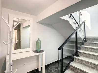 a staircase in a house with a mirror and a vase at On the Wave by LovelyStay in Paul do Mar