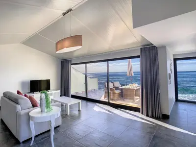 a living room with a couch and a view of the ocean at On the Wave by LovelyStay in Paul do Mar