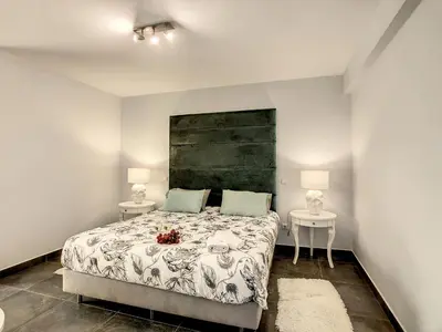 a bedroom with a bed with two tables and two lamps at On the Wave by LovelyStay in Paul do Mar