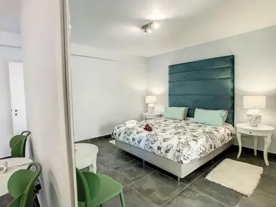 a bedroom with a bed with a blue headboard and two tables at On the Wave by LovelyStay in Paul do Mar