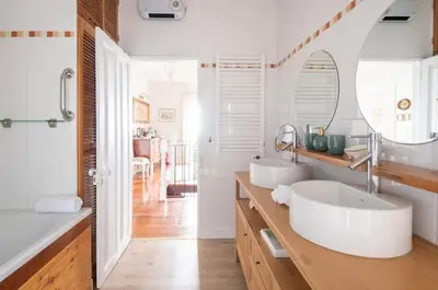 a white bedroom with a white bed and two lamps at Quinta Belmonte with Private Heated Pool in Funchal in Funchal