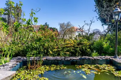 a house with a swimming pool in a garden at Quinta Belmonte with Private Heated Pool in Funchal in Funchal