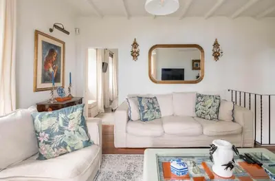 a living room with a staircase and a blue chair at Quinta Belmonte with Private Heated Pool in Funchal in Funchal