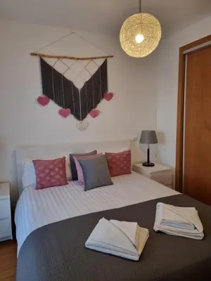 a bedroom with a large bed with towels on it at Casa Savannah Sun in Caniço