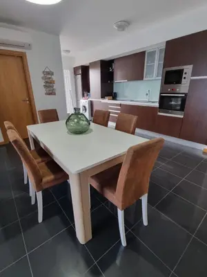 a white table and chairs in a kitchen at Casa Savannah Sun in Caniço