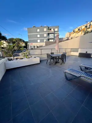 a patio with a table and chairs on a building at Casa Savannah Sun in Caniço
