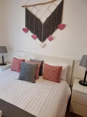 a bedroom with a bed with hearts on the wall at Casa Savannah Sun in Caniço
