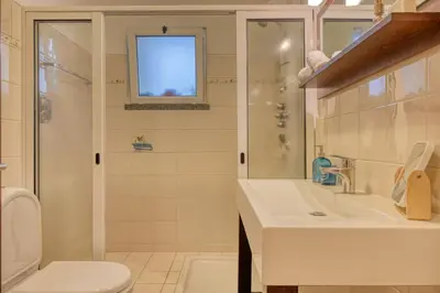 a bathroom with a toilet and a sink and a shower at Lidia's Place, a Home in Madeira in Ponta do Sol