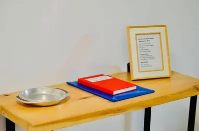 a table with a bowl and a plate and a book at Apartamento da vila, Porto Santo. in Vila Baleira