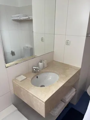 a bathroom with a sink and a mirror at Apartamento da vila, Porto Santo. in Vila Baleira