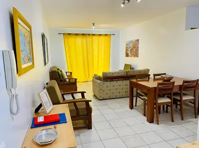 a living room with a table and a couch at Apartamento da vila, Porto Santo. in Vila Baleira