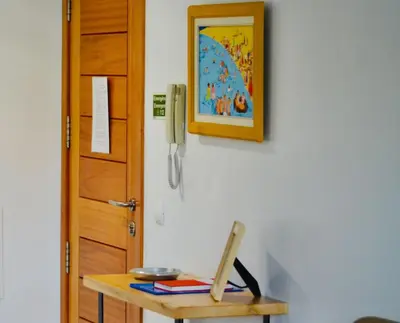a table with a phone on a wall next to a door at Apartamento da vila, Porto Santo. in Vila Baleira