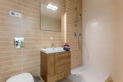 a bathroom with a sink and a toilet and a mirror at Burgau 2floor appt in condominium w/ shared pool in Burgau