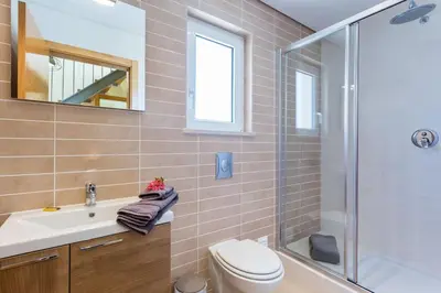 a bathroom with a toilet and a sink and a shower at Burgau 2floor appt in condominium w/ shared pool in Burgau