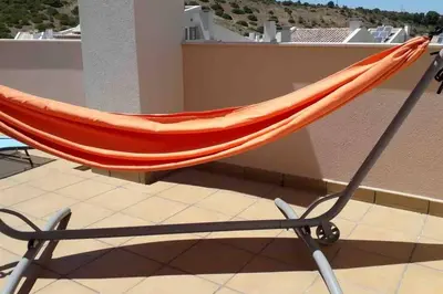 an orange hammock sitting on top of a balcony at Burgau 2floor appt in condominium w/ shared pool in Burgau