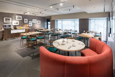 a restaurant with tables and chairs in a room at Barceló Funchal Oldtown in Funchal