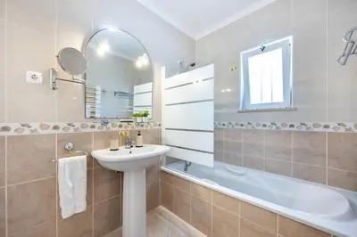 a bathroom with a sink and a bath tub at Casa Da Bauhinia in Aljezur
