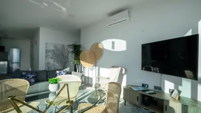 a living room with a couch and a tv at Casa Erbozeta by LovelyStay in Funchal