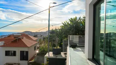 a balcony with a view of the ocean from a house at Casa Erbozeta by LovelyStay in Funchal
