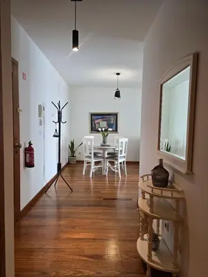 a dining room with a table and white chairs at Ocean Pearl Apartment W in Funchal