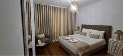 a bedroom with a bed and a chair in it at Ocean Pearl Apartment W in Funchal