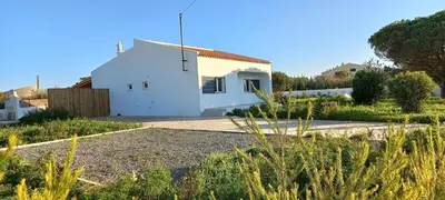 a white house in the middle of a yard at Casa Oliveira in Sagres