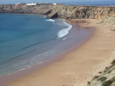 an aerial view of a beach with people in the water at Casa Oliveira in Sagres