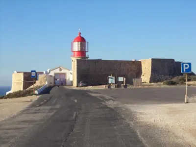a red and white lighthouse on the side of a road at Casa Oliveira in Sagres