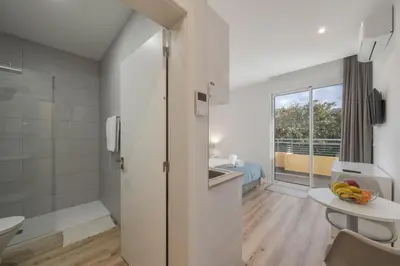 a white bathroom with a sink and a shower at Art Deco Central Apartments, Funchal in Funchal