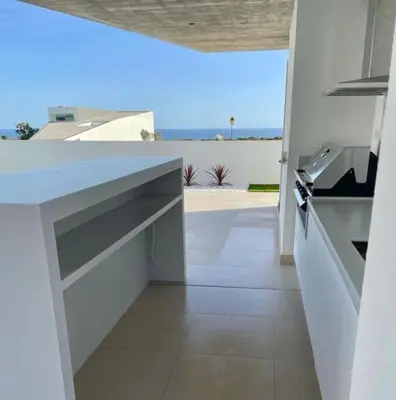 a white kitchen with a view of the ocean at Ocean view Architectural Modern Villa in Burgau