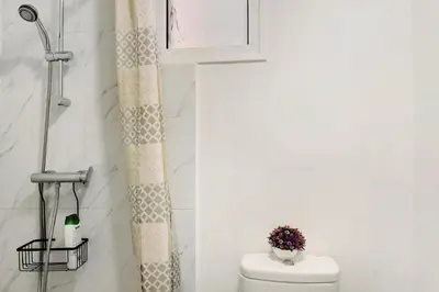 a bathroom with a toilet and a window at Funchal House in Funchal