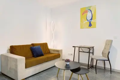 a living room with a couch and a table at Funchal House in Funchal
